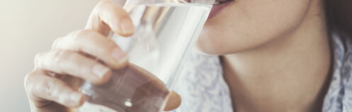 Young woman drinking pure glass of water